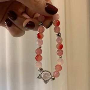 Pink and red beaded bracelet with kitty pendant